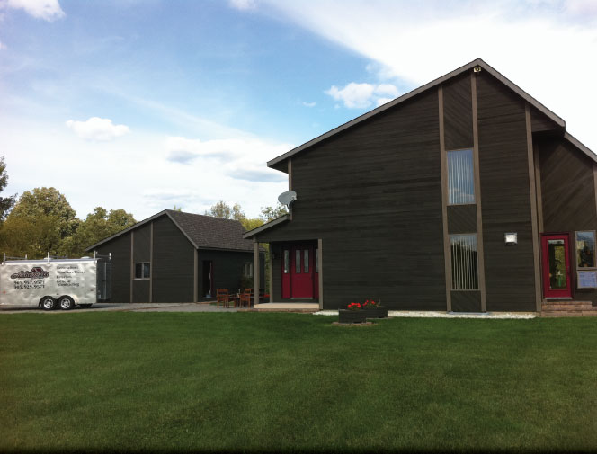 View of house & garage with new soffit & fascia.